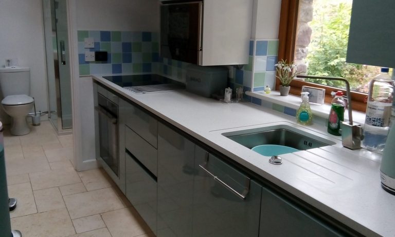 Professionally cleaned modern kitchen in Ammanford with spotless worktops and tiled floor